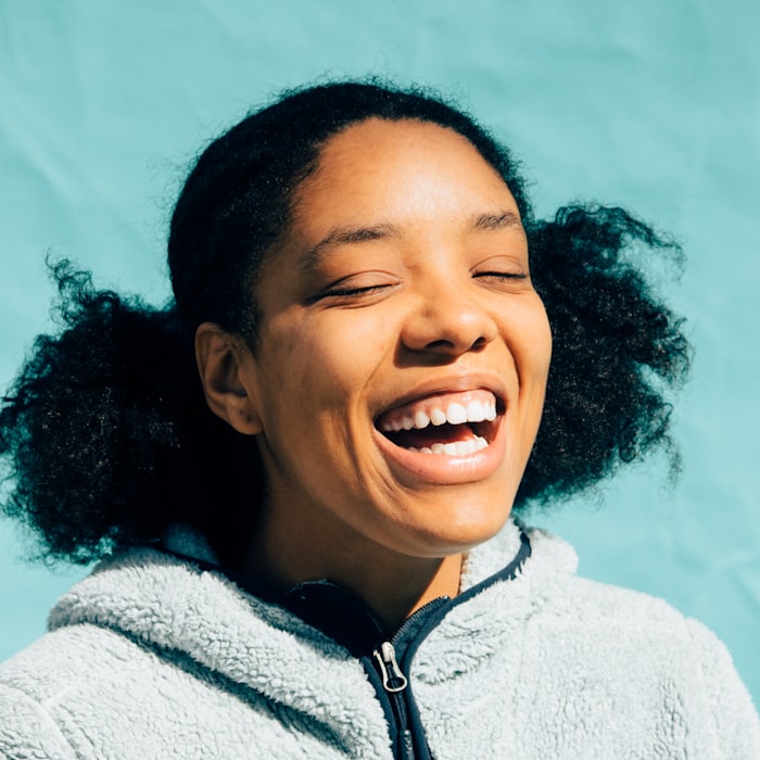 A woman laughing in the sun