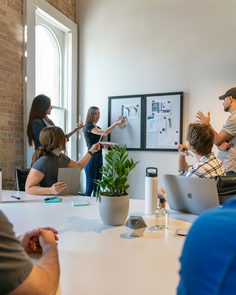 A team discussing work pinned to an office wall
